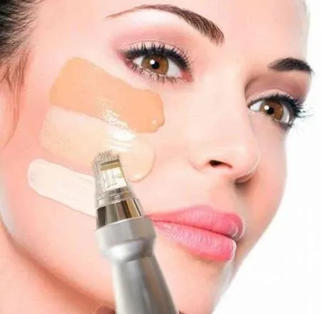 Close-up of a woman's face applying three shades of foundation on her cheek with a makeup tool. The image conveys elegance and precision in makeup application.